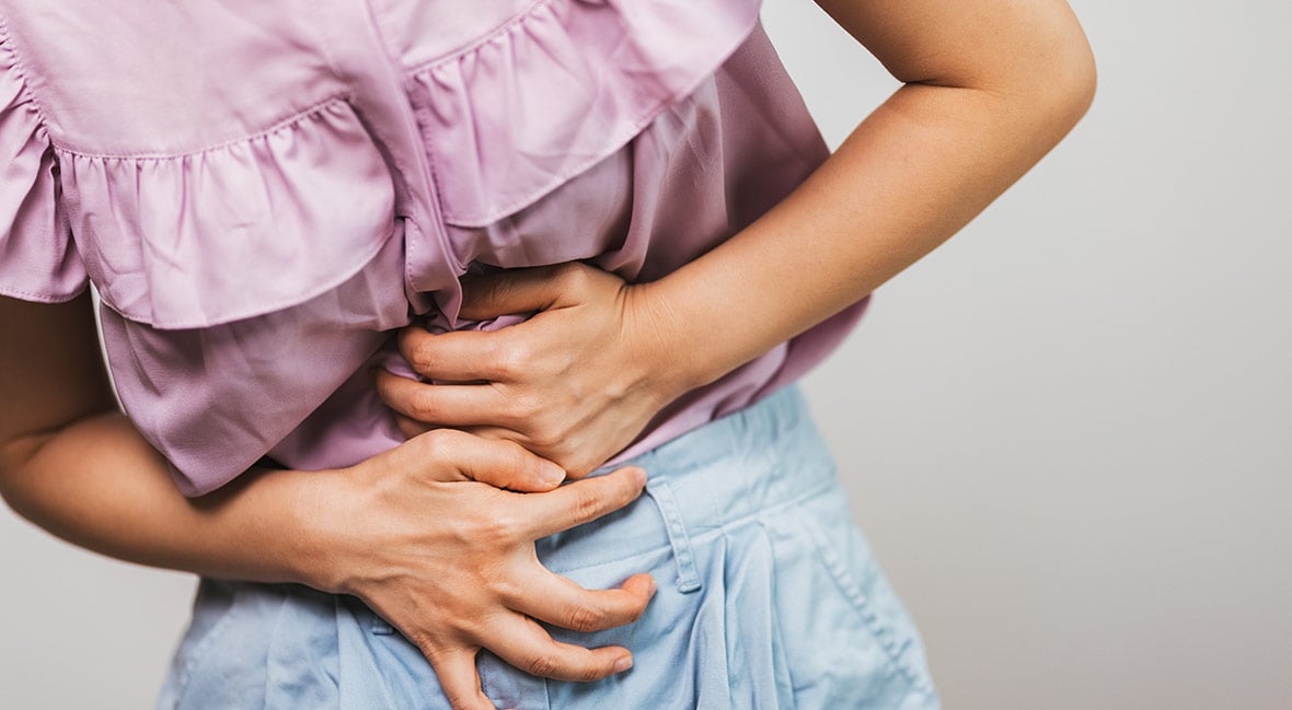 a woman holding her stomach in pain