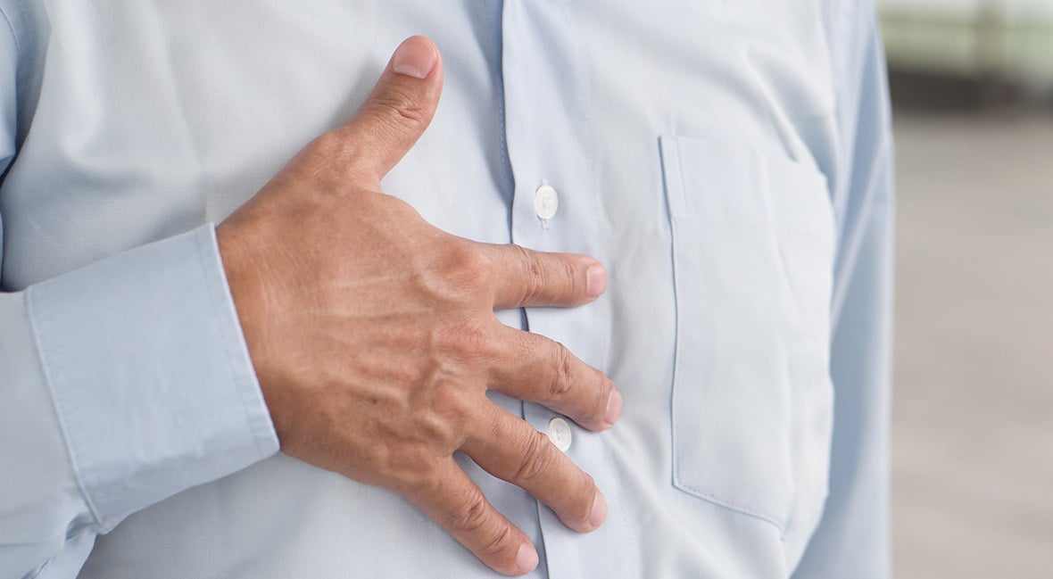 hand of senior old man holding chest