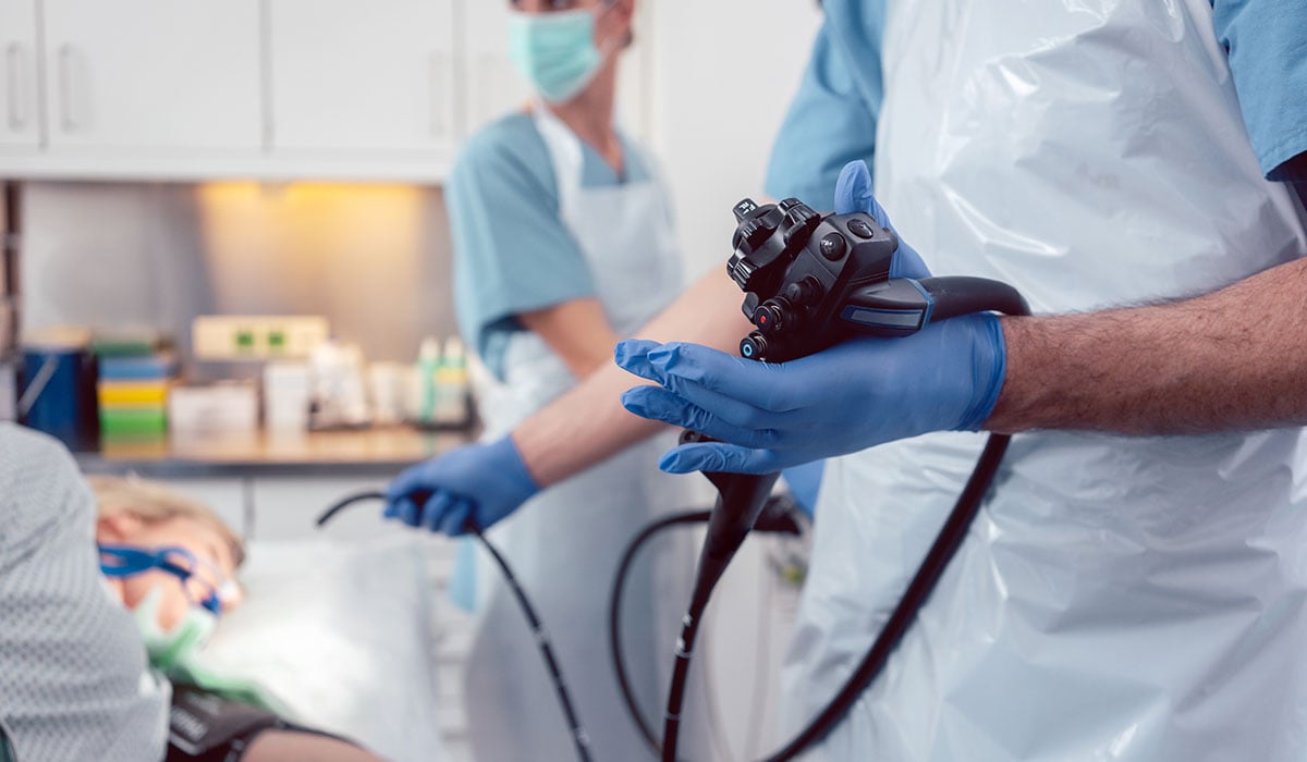 doctor holding endoscope in front of patient