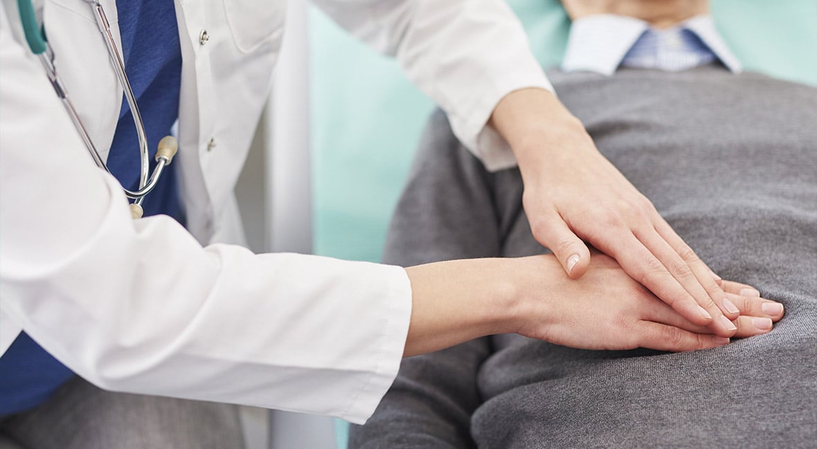 Close up of doctor examining stomach of senior man